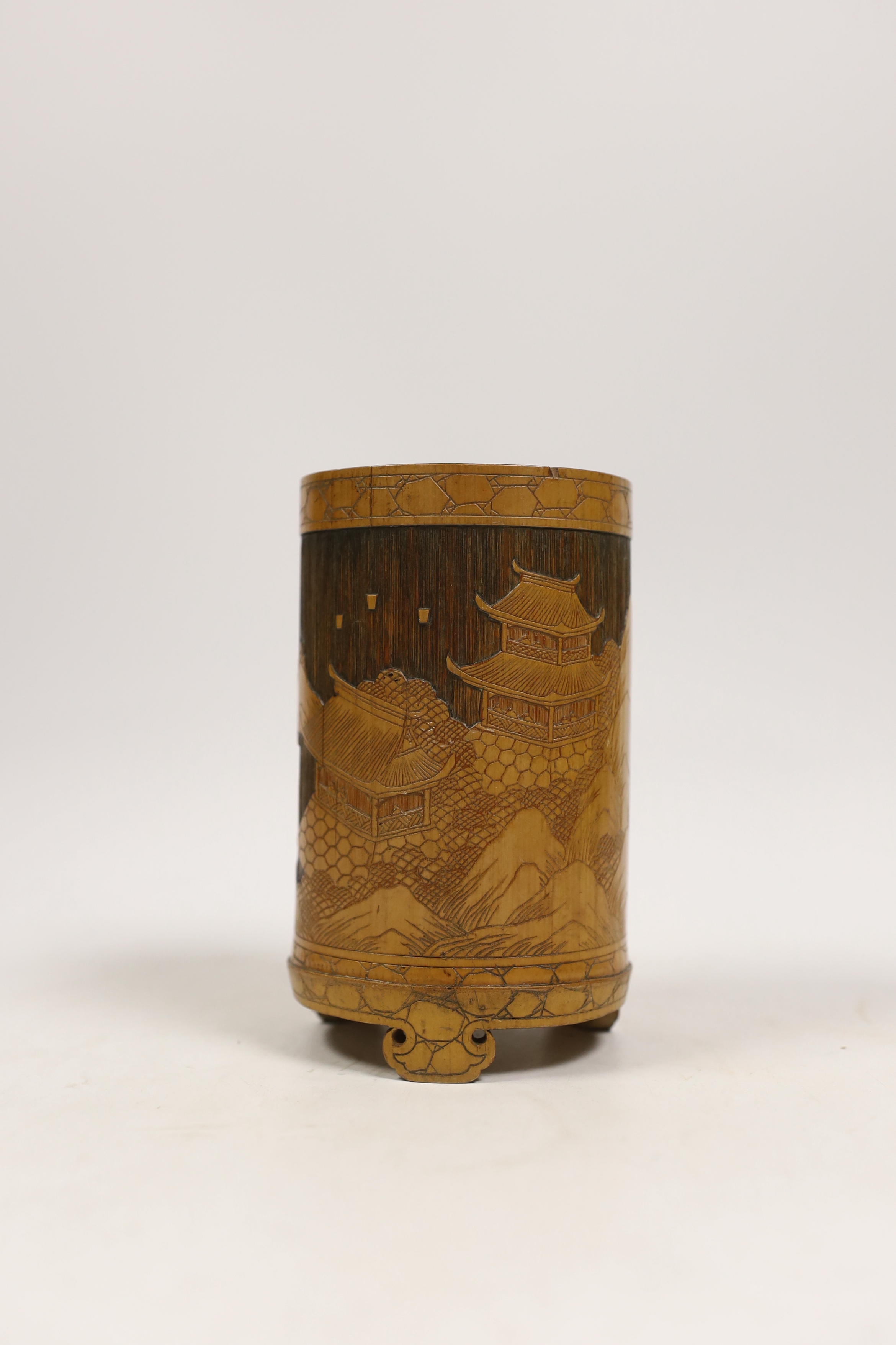 A Japanese bamboo brushpot carved with mountains and pagodas, 13cm high